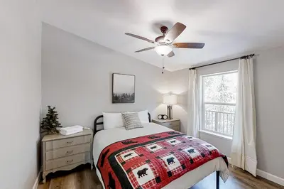 a bedroom with a bed and a ceiling fan at Out in the Wild in Oakhurst