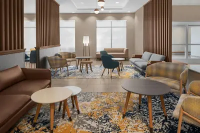 a lobby with couches and tables and chairs at TownePlace Suites by Marriott Sacramento Rancho Cordova in Rancho Cordova