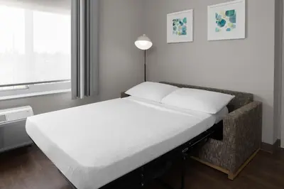a bed in a room next to a window at TownePlace Suites by Marriott Sacramento Rancho Cordova in Rancho Cordova