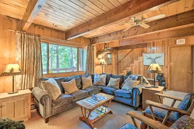 a living room with a couch and a table at Comfortable Mi-Wuk Village Cabin Hike and Ski! in Mi-Wuk Village