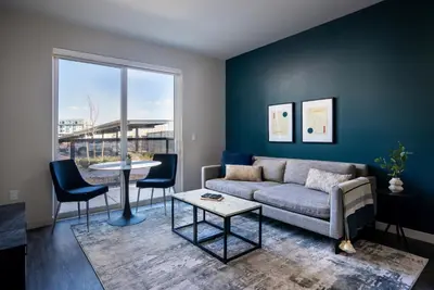 a living room with a couch and a table at Kasa Archive Reno-Tahoe in Reno