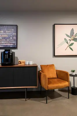 a living room with a chair and a cabinet at Kasa Archive Reno-Tahoe in Reno