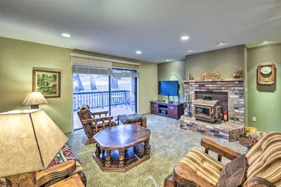 a living room with a table and a fireplace at Near Fishing and Hiking Pioneer Cabin with Decks in Pioneer