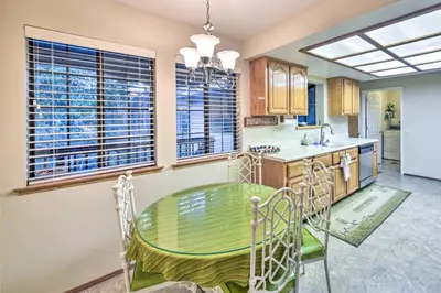 a kitchen with a green table and chairs in it at Near Fishing and Hiking Pioneer Cabin with Decks in Pioneer