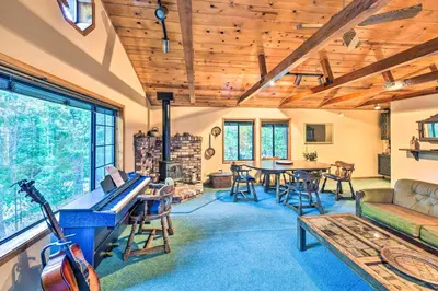 a living room with a piano and a table at Near Fishing and Hiking Pioneer Cabin with Decks in Pioneer