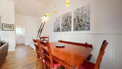 a dining room with a wooden table and chairs at Forest Creek #15 condo in Mammoth Lakes
