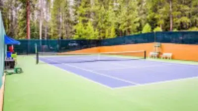 a tennis court with a tennis racket on it at Whiskey Springs by AvantStay Classic Cabin Near Tahoe Donner Ski Area in Truckee