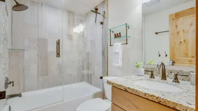 a bathroom with a tub and a sink and a toilet at Arroyo by AvantStay Peaceful Mountain Townhouse w Large Private Balcony in Kingswood Estates