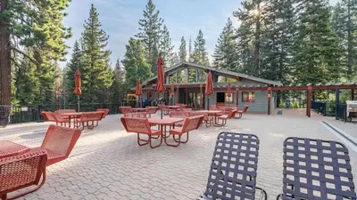 a patio with tables and chairs in front of a building at Arroyo by AvantStay Peaceful Mountain Townhouse w Large Private Balcony in Kingswood Estates