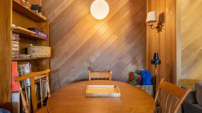 a dining room with a wooden table and chairs at Fawn by AvantStay Secluded Cabin w Large Deck Surrounded by Forest in Tahoma Meadows