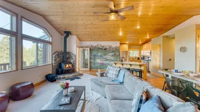a living room with a couch and a table at Golden Summit by AvantStay Stunning Secluded Cabin w Access to Tahoe Donner in Truckee