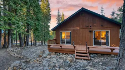 a small cabin in the middle of a forest at Golden Summit by AvantStay Stunning Secluded Cabin w Access to Tahoe Donner in Truckee