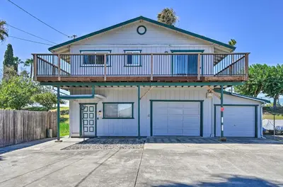 a house with a balcony on top of it at Waterfront Bethel Island Home with Dock and Slip in Bethel Island