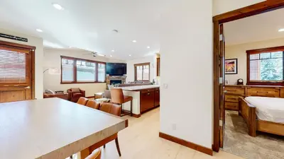 a living room with a bed and a dining room at Lakeview Townhomes #5 townhouse in Mammoth Lakes