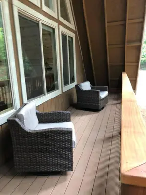 a porch with two chairs and two windows at Modern Cabin Get Away - close to APPLE HILL in Pollock Pines