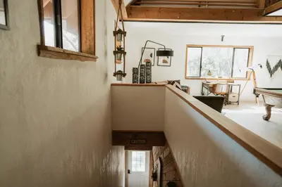 a staircase in a house with a living room at Romantic Forest Lovers Nest by Casa Oso in Mariposa