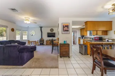 a living room with a couch and a kitchen at Acorn House - Charming house in green heaven with pool table with lovely backyard in Oakhurst