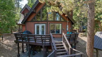 a tiny house in the woods with a deck at Ember by AvantStay Majestic Entertainers Home w Pine Tree Views Close to Meeks Bay in Tahoma Meadows
