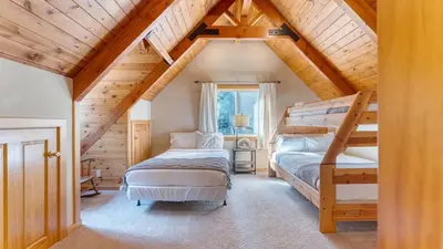 a attic bedroom with two bunk beds and a ladder at Ember by AvantStay Majestic Entertainers Home w Pine Tree Views Close to Meeks Bay in Tahoma Meadows