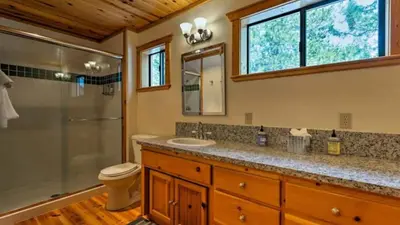 a bathroom with a toilet sink and a shower at Black Bear by AvantStay Spacious Viking Lodge in Tahoe Donner w Game Room Hot Tub in Truckee