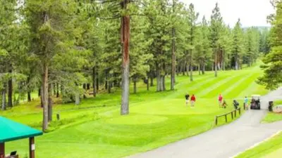 a group of people playing golf on a golf course at Black Bear by AvantStay Spacious Viking Lodge in Tahoe Donner w Game Room Hot Tub in Truckee