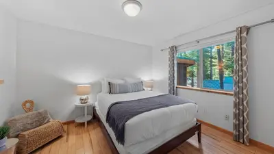 a bedroom with a bed and a window at Moosetrack by AvantStay Cozy Cabin w Hot Tub In The Heart of Tahoe Donner in Truckee