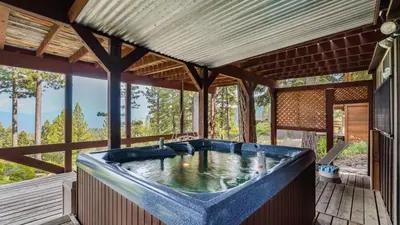 a large blue tub in a house with trees at Horizon by AvantStay Stunning A-frame Cabin w Hot Tub Billiards Lake Views in Tahoe City