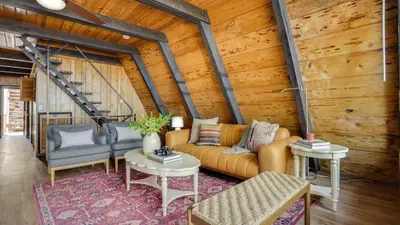 a living room with a couch and two chairs at Horizon by AvantStay Stunning A-frame Cabin w Hot Tub Billiards Lake Views in Tahoe City