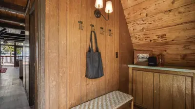 a room with a wooden wall with a bag on the wall at Horizon by AvantStay Stunning A-frame Cabin w Hot Tub Billiards Lake Views in Tahoe City