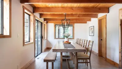 a dining room with a wooden table and chairs at Timberline by AvantStay Stunning Chalet Cabin w Hot Tub Pool Table Home Theater in Tahoe Vista
