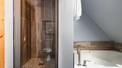 a bathroom with a bath tub and a toilet at Timberline by AvantStay Stunning Chalet Cabin w Hot Tub Pool Table Home Theater in Tahoe Vista