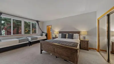 a bedroom with a bed and a large window at Sparrow by AvantStay Modern Mountain Retreat w Hot Tub Pool Table Games in Truckee