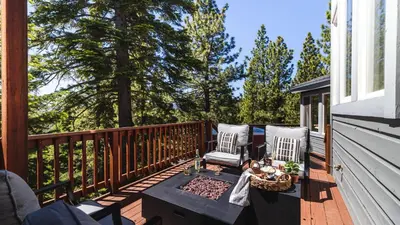 a deck with two chairs and a table at Sparrow by AvantStay Modern Mountain Retreat w Hot Tub Pool Table Games in Truckee