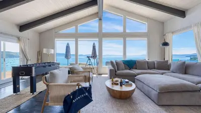 a living room with a couch and a table at Lakeview by AvantStay Private Waterfront Cabin on Lake Tahoe w Hot Tub Views in Tahoe Vista