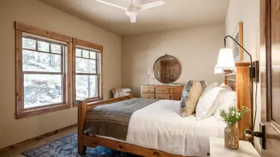 a bedroom with a bed and a mirror and a window at Lakefront Home in Kings Beach w Views • Prime Location Atkinson by Avantstay in Tahoe Vista