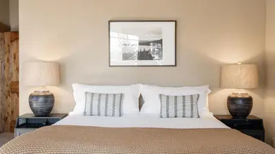 a bedroom with a large bed with two lamps at Lakefront Home in Kings Beach w Views • Prime Location Atkinson by Avantstay in Tahoe Vista