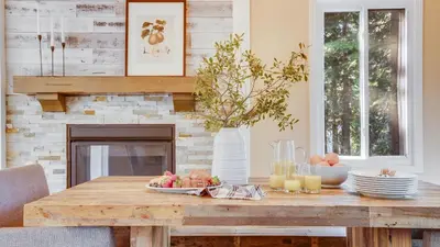 a table with a bowl of fruit on it in a living room at Hot Tub Sauna Game Room Modern 5BDR Family Cabin Homewood by AvantStay in Tahoma Meadows
