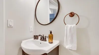 a bathroom with a sink and a mirror at Hot Tub Sauna Game Room Modern 5BDR Family Cabin Homewood by AvantStay in Tahoma Meadows