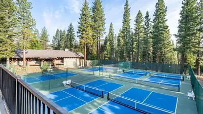 a tennis court with two tennis courts at Wolfe by AvantStay 5mins NorthStar Fireplace 2 Private Decks in Ponderosa Fairway Estates
