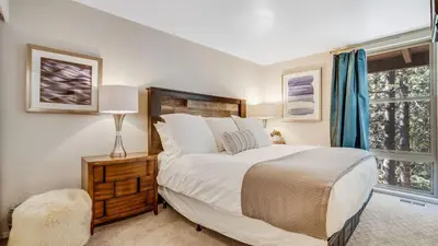 a bedroom with a large bed and a window at Pinegrove by AvantStay Beautiful Villas Condo just outside Tahoe City in Dollar Point