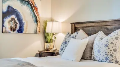 a bedroom with a bed with blue and white pillows at Pinegrove by AvantStay Beautiful Villas Condo just outside Tahoe City in Dollar Point