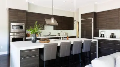 a kitchen with a large white island with chairs at Quartz by AvantStay Stunning Home In Truckee w Views in Ponderosa Fairway Estates