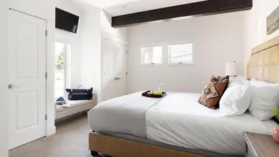 a white bedroom with a bed and a couch at Quartz by AvantStay Stunning Home In Truckee w Views in Ponderosa Fairway Estates