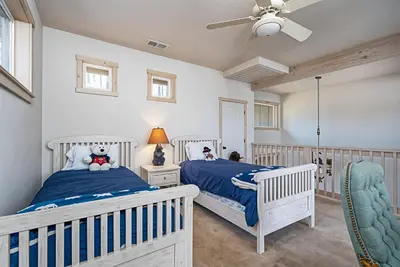 a bedroom with two beds and a ceiling fan at Lakefront Casa Cassaretto in Groveland