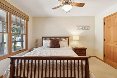 a bedroom with a bed and a ceiling fan at Better at the Lake Home with Private Dock in Groveland