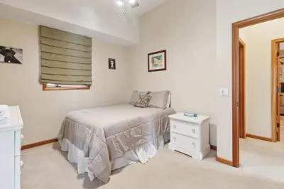 a bedroom with a bed and a nightstand and a window at Better at the Lake Home with Private Dock in Groveland