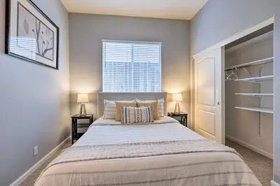 a bedroom with a large bed with two night stands at Spacious Folsom Getaway with Pool and Hot Tub! in Folsom