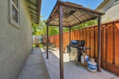 a barbecue grill with a wooden canopy on a patio at Spacious Folsom Getaway with Pool and Hot Tub! in Folsom