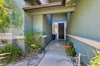 a walkway leading to the door of a house at Spacious Folsom Getaway with Pool and Hot Tub! in Folsom