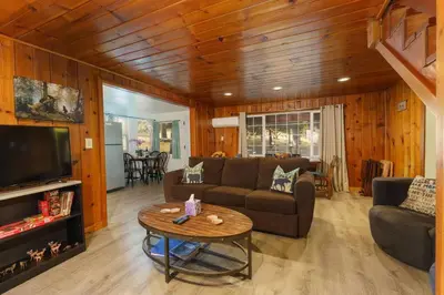 a living room with a couch and a table at Acorn Cabin - Charming Place, Your getaway to Yosemite, Bass Lake in Oakhurst